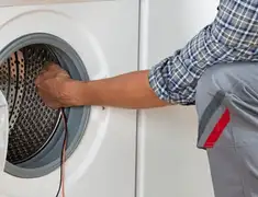 Dryer repair technician diagnosing and servicing a clothes dryer in Columbia, SC