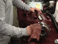 Vacuum repair technician cleaning and servicing a vacuum motor in Columbia, SC