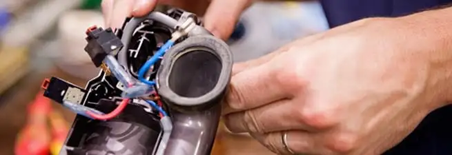 Vacuum repair technician reconnecting wiring and components in Columbia, SC