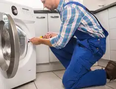 Washing machine repair technician servicing a front-load washer in Columbia, SC